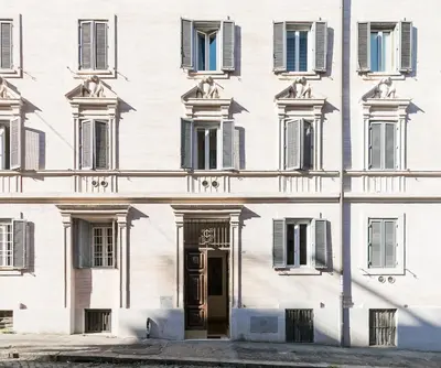 a white building with windows and a door at Appartamenti MarcoAurelio49 in Rome