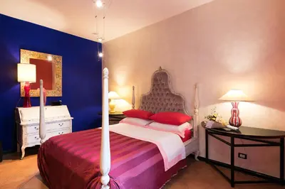 a bedroom with a bed and a blue wall at Appartamenti MarcoAurelio49 in Rome