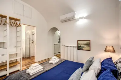 a bedroom with a large blue bed in a room at FRESH HOUSE NAVONA in Rome
