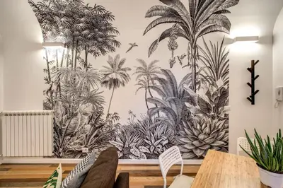 a living room with a wall mural of plants at FRESH HOUSE NAVONA in Rome