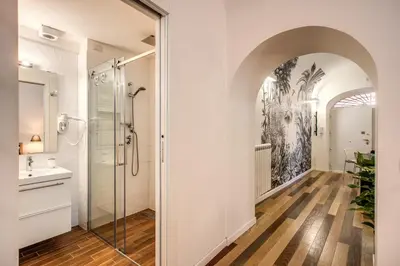 a bathroom with a shower and a glass shower stall at FRESH HOUSE NAVONA in Rome