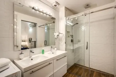 a white bathroom with a sink and a shower at FRESH HOUSE NAVONA in Rome
