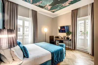 a bedroom with a bed with a painting on the ceiling at Hotel 55 Fifty-Five - Maison d'Art Collection in Rome