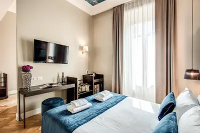 a hotel room with a bed and a television at Hotel 55 Fifty-Five - Maison d'Art Collection in Rome