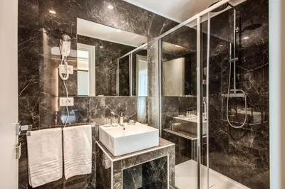 a bathroom with a sink and a shower at Hotel 55 Fifty-Five - Maison d'Art Collection in Rome