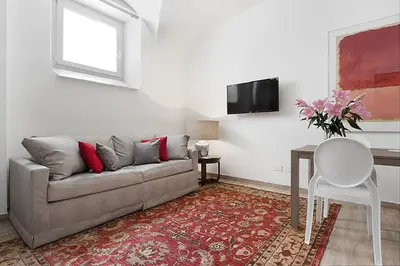 a living room with a couch and a table at BMGA l Mon Amour San Giovanni Apartment in Rome