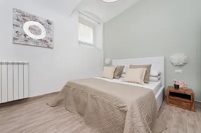 a white bedroom with a bed and a window at BMGA l Mon Amour San Giovanni Apartment in Rome