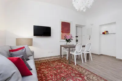a living room with a couch and a table and chairs at BMGA l Mon Amour San Giovanni Apartment in Rome