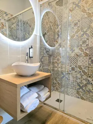 a bathroom with a sink and a shower at AmoRoma Suite in Rome