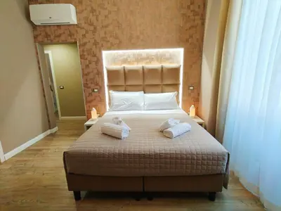a bedroom with a large bed with towels on it at AmoRoma Suite in Rome