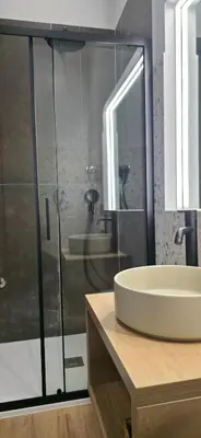 a bathroom with a sink and a glass shower at AmoRoma Suite in Rome