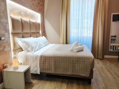 a bedroom with a bed with two white towels on it at AmoRoma Suite in Rome