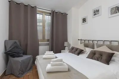 a bedroom with two beds and a chair at Take You Rome - Vatican Apartment in Rome