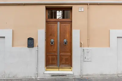 a wooden door on the side of a building at Take You Rome - Vatican Apartment in Rome