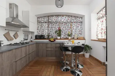 a kitchen with a window and a table with stools at Take You Rome - Vatican Apartment in Rome