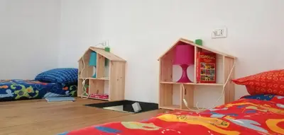 a room with a bed and two shelves in a room at Gli Alberi a Testaccio in Rome