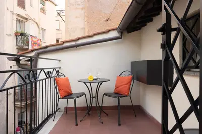 a patio with two chairs and a table on a balcony at Flat PIAZZA DEL POPOLO in Rome