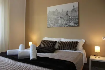 a bedroom with a bed with two candles on it at Panoramic View of St. Peter in Rome