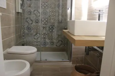 a bathroom with a toilet and a sink and a tub at Panoramic View of St. Peter in Rome