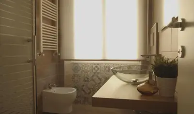 a bathroom with a sink and a glass bowl on a counter at Panoramic View of St. Peter in Rome