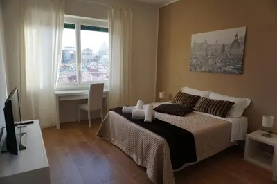 a bedroom with a bed and a large window at Panoramic View of St. Peter in Rome
