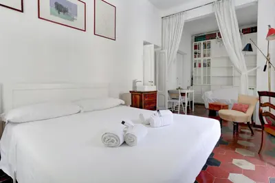 a bedroom with a white bed with towels on it at Charming Colosseum in Rome