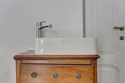 a bathroom sink on top of a wooden table at Charming Colosseum in Rome