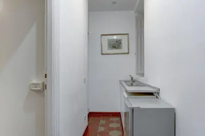 a white bathroom with a sink and a mirror at Charming Colosseum in Rome