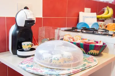 a kitchen counter with a mixer and a plate with cupcakes at Da Merion in Rome