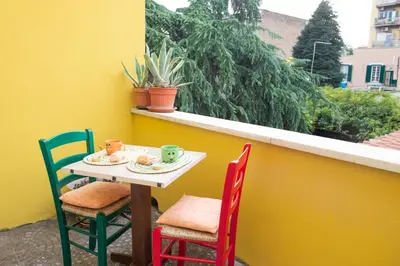 a small table and chairs sitting on a balcony at Da Merion in Rome