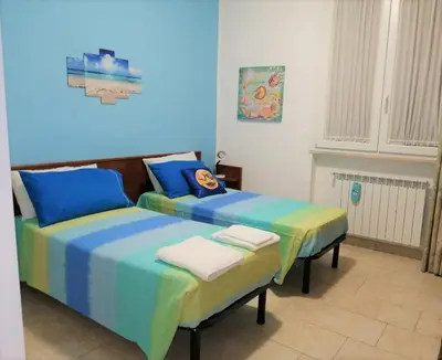 two beds sitting next to each other in a room at Da Merion in Rome