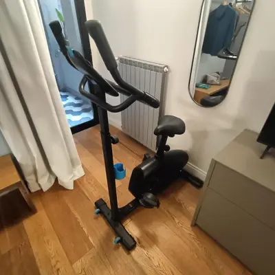 an exercise bike in a room with a mirror at LikeYourHome, 80 sq m luxury apartment with Jacuzzi, in Trastevere district in Rome