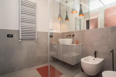 a bathroom with a sink and a toilet at LikeYourHome, 80 sq m luxury apartment with Jacuzzi, in Trastevere district in Rome