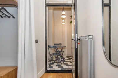 a hallway with a mirror and a table in a room at LikeYourHome, 80 sq m luxury apartment with Jacuzzi, in Trastevere district in Rome