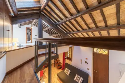 an attic conversion of a house with wooden beams at Amazing studio in Campo de Fiori - FromHometoRome in Rome