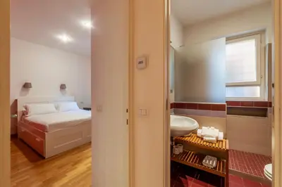 a small bathroom with a bed and a sink at Apartment with terrace near Piazza Navona - FromHometoRome in Rome