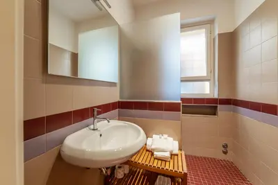 a bathroom with a sink and a mirror at Apartment with terrace near Piazza Navona - FromHometoRome in Rome
