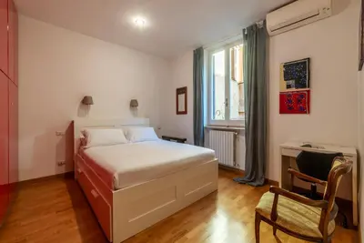 a bedroom with a bed and a desk and a chair at Apartment with terrace near Piazza Navona - FromHometoRome in Rome