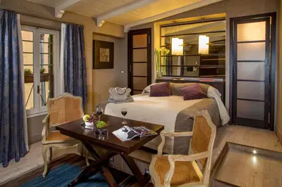 a bedroom with a bed and a table and chairs at The Inn at the Spanish Steps Luxury Collection - Premium Studio Room in Rome