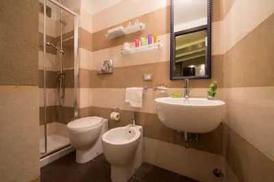 a bathroom with a sink and a toilet and a mirror at The Inn at the Spanish Steps Luxury Collection - Premium Studio Room in Rome