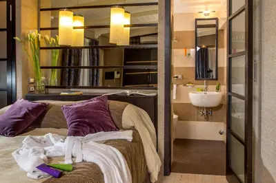 a bathroom with a bed and a sink in a room at The Inn at the Spanish Steps Luxury Collection - Premium Studio Room in Rome