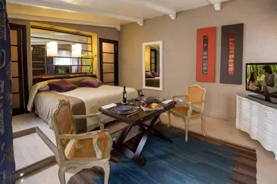 a bedroom with a bed and a table and chairs at The Inn at the Spanish Steps Luxury Collection - Premium Studio Room in Rome