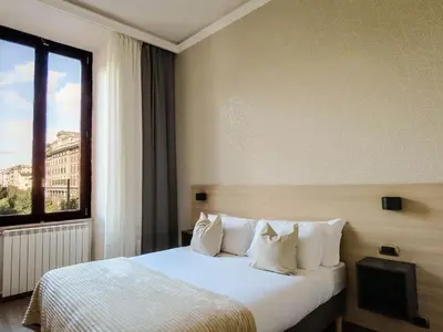 a hotel room with a bed and a window at My Maison 70 Guest House in Rome