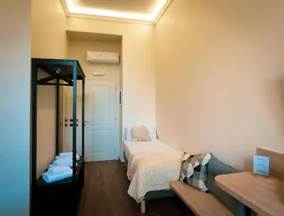 a small room with a bed and a mirror at My Maison 70 Guest House in Rome