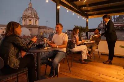 a group of people sitting at tables in a restaurant at Campo de' Fiori 34 in Rome