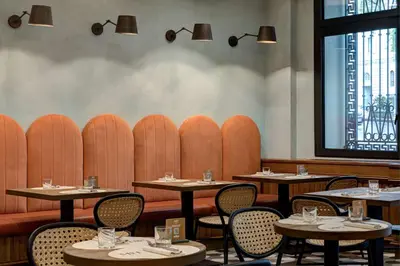 a dining room with tables and chairs and a window at DoubleTree By Hilton Rome Monti in Rome
