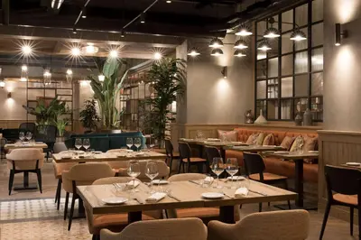 a restaurant with tables and chairs and lights at DoubleTree By Hilton Rome Monti in Rome