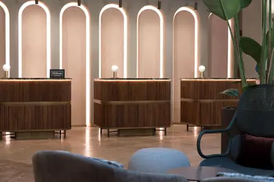a row of desks in a room with chairs at DoubleTree By Hilton Rome Monti in Rome