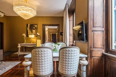 a living room with a couch and a chandelier at The Inn at the Spanish Steps Luxury Collection - The Club Condotti 91 in Rome