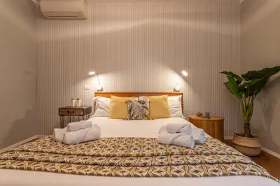 a bedroom with a large bed with towels on it at Kitty Apartment - Close to the Vatican in Rome